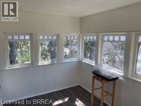Brantford apartment for rent - A room with white walls and a wooden stool.