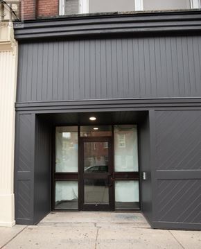 Stratford multi-family for rent - A black building with a glass door and a window.