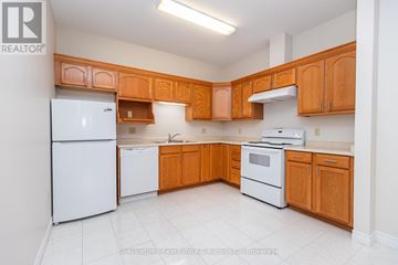 Stratford multi-family for rent - A kitchen with wooden cabinets and white appliances.