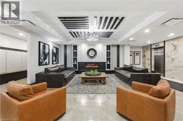 Stoney Creek condo for rent - A living room with a fireplace and a couch.