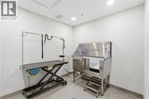 Stoney Creek condo for rent - A clean room with a table and a machine.