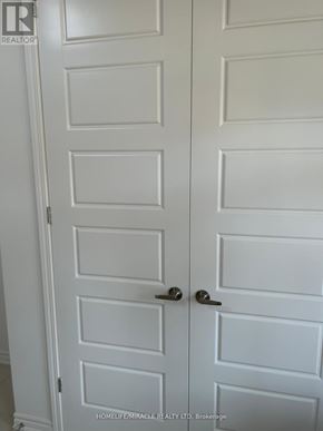 Kitchener apartment for rent - A white door with a handle and a lock.