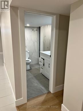 Toronto (Willowridge-Martingrove-Richview) apartment for rent - A bathroom with a toilet, sink and mirror.