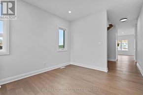 Niagara Falls (Marineland) apartment for rent - A spacious room with wooden flooring and white walls.