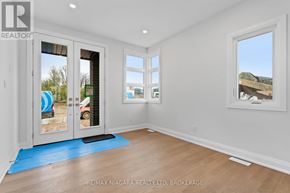 Niagara Falls (Marineland) apartment for rent - A room with a blue rug and a window with a view of a construction site.