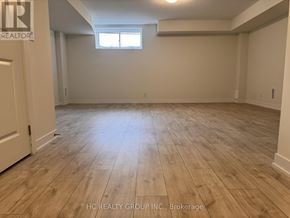 Markham (Angus Glen) townhouse for rent - A room with wooden flooring and a window.
