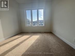 Markham (Angus Glen) townhouse for rent - A room with a large window and carpeted floor.