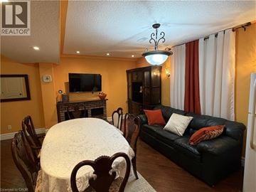 Hamilton apartment for rent - A living room with a black couch and a fireplace.