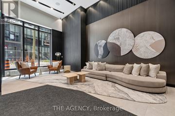 Toronto (Mount Pleasant West) condo for rent - A modern living room with a large couch and a rug.