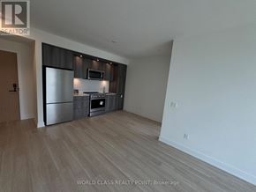 Toronto (Islington-City Centre West) condo for rent - A spacious kitchen with wooden flooring and modern appliances.