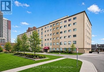 Toronto (Dovercourt-Wallace Emerson-Junction) condo for rent - A large beige building with a red awning is the RE/MAX Excel Titan in Brokerage.