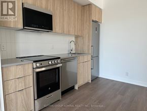 Toronto (High Park North) condo for rent - A kitchen with a stove top oven and microwave above it.