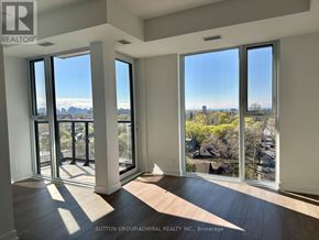Toronto (High Park North) condo for rent - A room with a view of the city through large windows.