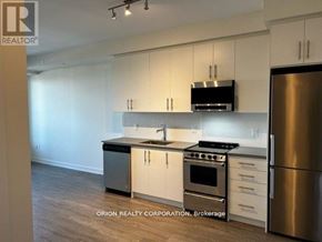 Hamilton (Beasley) condo for rent - A kitchen with white cabinets and stainless steel appliances.