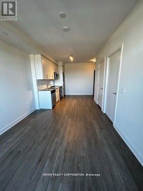 Hamilton (Beasley) condo for rent - A long, empty hallway with wood flooring and white walls.