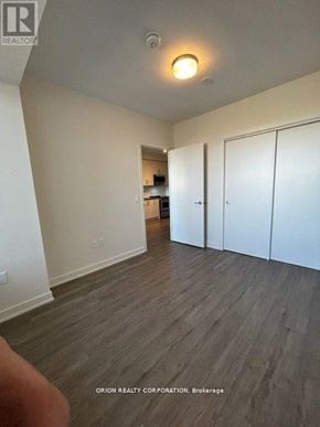 Hamilton (Beasley) condo for rent - A room with wood flooring and white walls, with a door on the right.