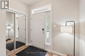 London North (North B) house for rent - A hallway with a mirror, two doors, and a lamp.