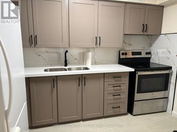 Toronto (Parkwoods-Donalda) condo for rent - A kitchen with brown cabinets and a white countertop.