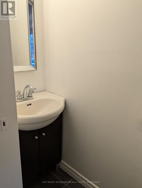 Kingston (Central City West) townhouse for rent - A bathroom with a sink and mirror.