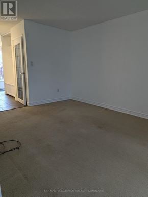 Kingston (Central City West) townhouse for rent - A room with a carpeted floor and a doorway leading to another room.