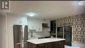 Toronto (Kennedy Park) condo for rent - A kitchen with a refrigerator, cabinets, and a countertop.