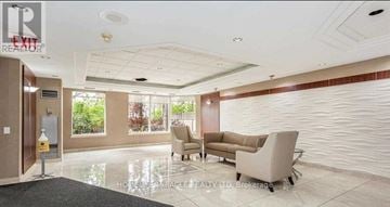 Mississauga (Cooksville) condo for rent - A living room with a grey carpet and white walls.