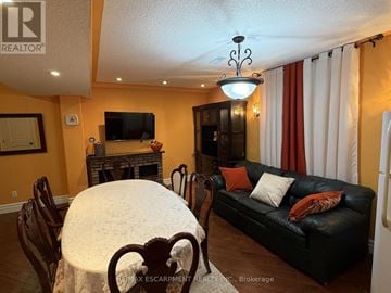 Hamilton (Jerome) apartment for rent - A living room with a black couch and a fireplace.