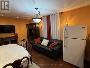 Hamilton (Jerome) apartment for rent - A living room with a black couch and a white refrigerator.