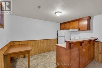 New Tecumseth (Alliston) apartment for rent - A kitchen with wooden cabinets and a white refrigerator.