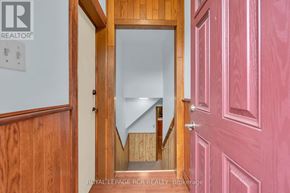 New Tecumseth (Alliston) apartment for rent - A doorway with a mirror in the middle of it.