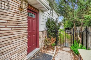 New Tecumseth (Alliston) apartment for rent - A red door is on the left side of a brick wall.