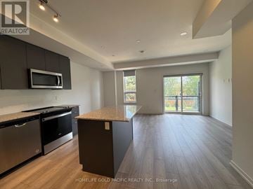 Newmarket (Glenway Estates) townhouse for rent - A kitchen with dark wood cabinets and stainless steel appliances.