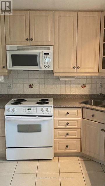 Toronto (Malvern) apartment for rent - A white stove and microwave in a kitchen.