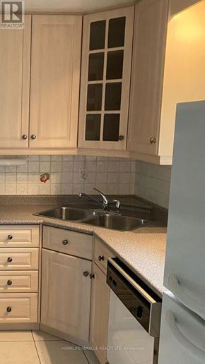 Toronto (Malvern) apartment for rent - A kitchen with wooden cabinets and a white fridge.