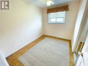 Toronto (Malvern) apartment for rent - A room with a rug on the floor and a window with a curtain.