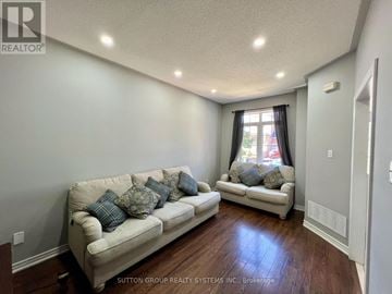 Hamilton (Stoney Creek) townhouse for rent - A living room with two couches and a window.