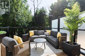 Mississauga (Mineola) townhouse for rent - A patio with a couch, chairs, and a table with a potted plant.