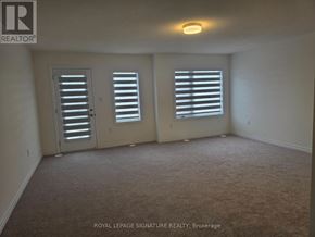 Brampton (Northwest Brampton) townhouse for rent - A room with carpet flooring and two windows with blinds.