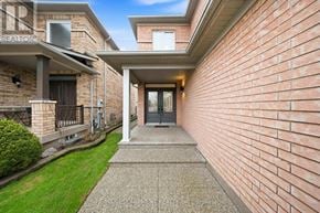 Mississauga (Churchill Meadows) apartment for rent - A red brick house with a black door and a glass window.
