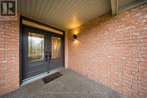 Mississauga (Churchill Meadows) apartment for rent - A house entrance with a grey door and a brick wall.