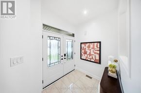 Mississauga (Churchill Meadows) apartment for rent - A hallway with a white door and a red and black painting on the wall.