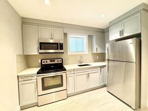 Surrey apartment for rent - A kitchen with a stove, oven, microwave, sink, and refrigerator.