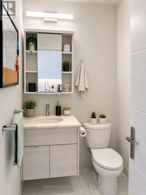 Kitchener condo for rent - A white bathroom with a toilet, sink, and shelves.