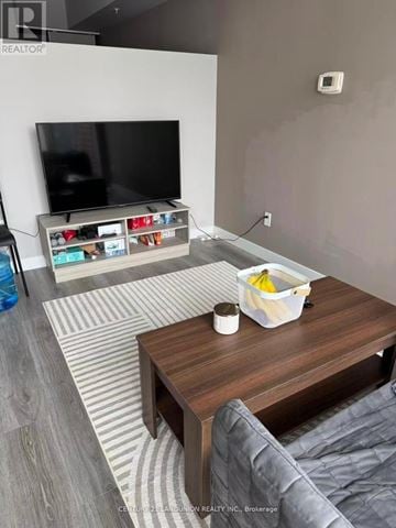 Waterloo condo for rent - A living room with a grey couch and a wooden coffee table.