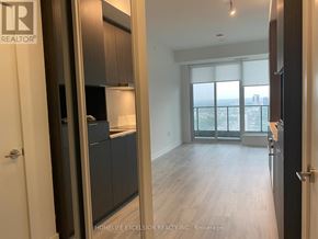 Toronto (Willowdale East) condo for rent - A room with a sliding glass door leading to a balcony.