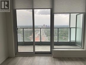 Toronto (Willowdale East) condo for rent - A room with a view of the city through large windows.