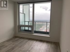 Toronto (Willowdale East) condo for rent - A room with a large window overlooking a cityscape.