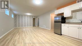 Barrie (Georgian Drive) apartment for rent - A kitchen area with wooden flooring and white cabinets.