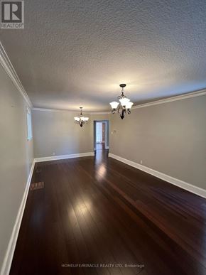 Toronto (Clairlea-Birchmount) apartment for rent - A hallway with wood floors and a chandelier.