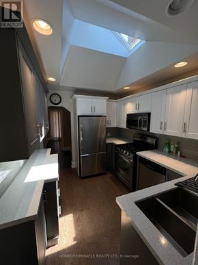 Toronto (Clairlea-Birchmount) apartment for rent - A kitchen with a stainless steel refrigerator and microwave.